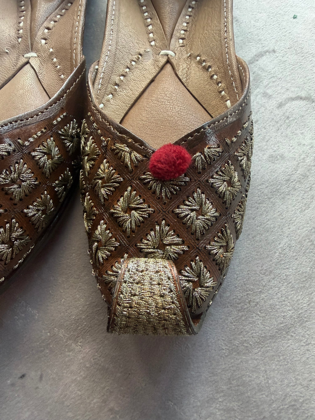 Gold Embroidered Punjabi Jutti – Brown Leather with Red Pom Pom